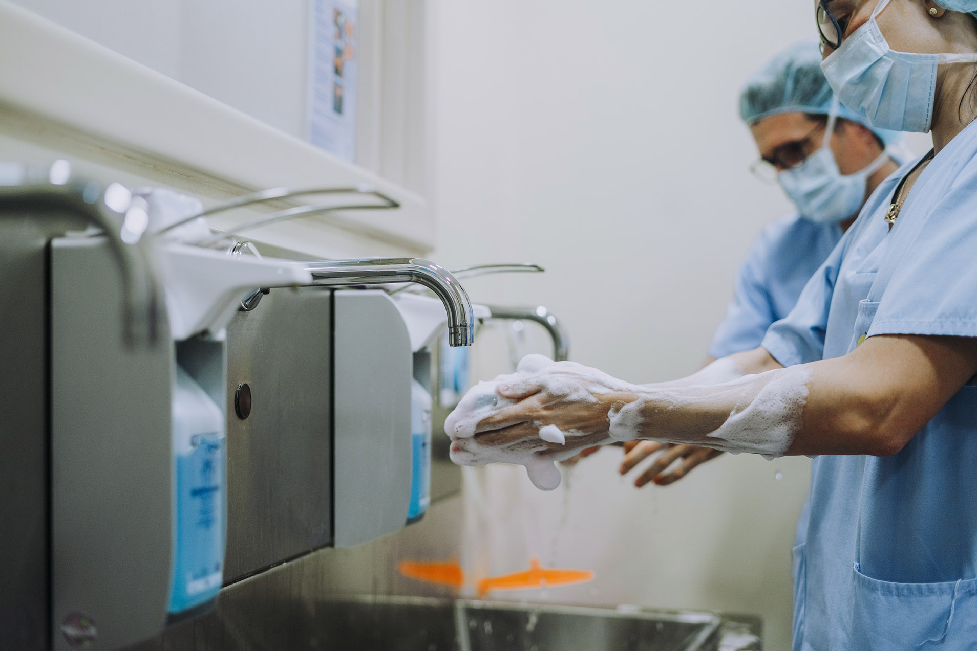 Unrecognizable doctor washing hands before operating